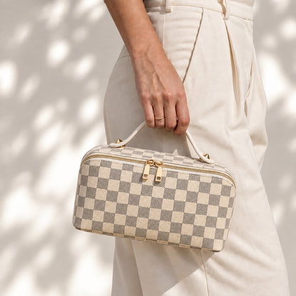 Packly Checkered Beige makeup bag carried by its top handle